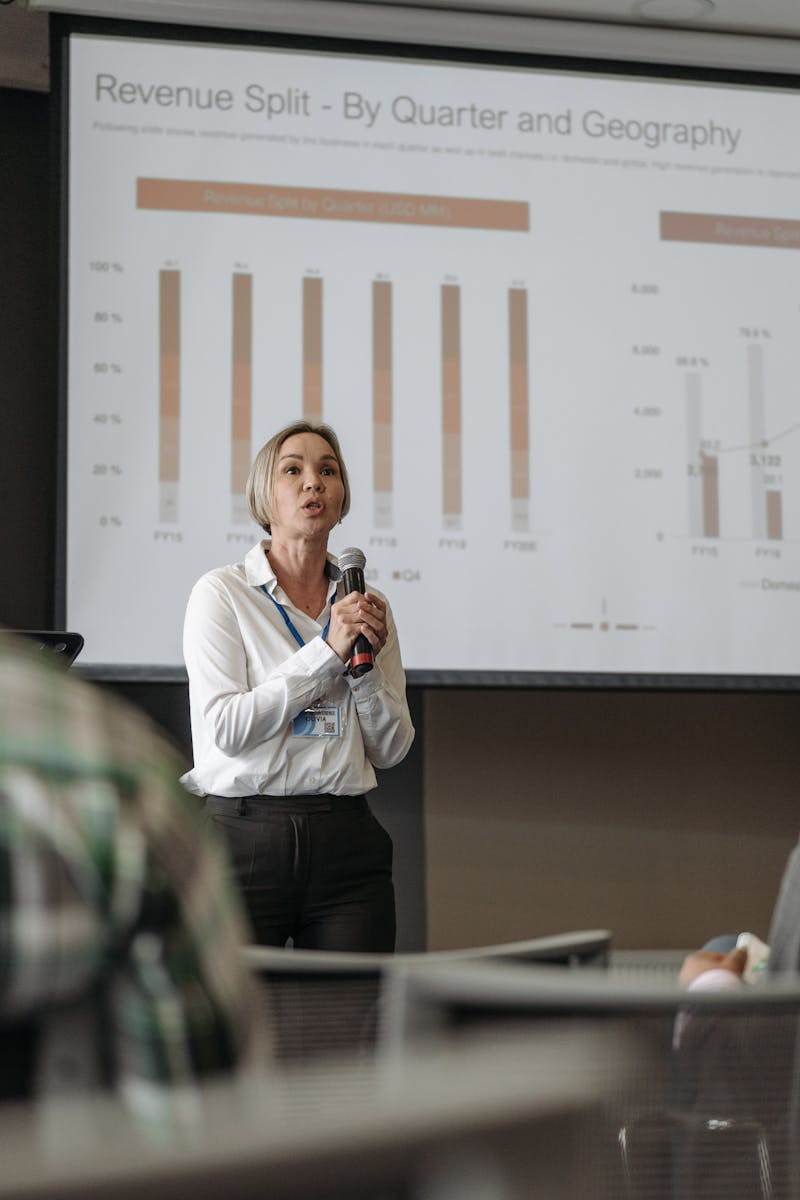 Professional presentation on revenue split by quarter and geography during a business conference.